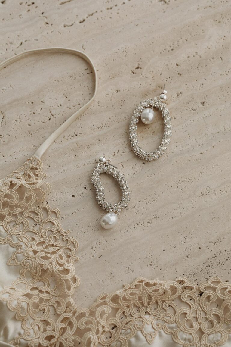 kaboompics satin light beige bra trimmed with lace silver earrings with zircons and pearls 31788